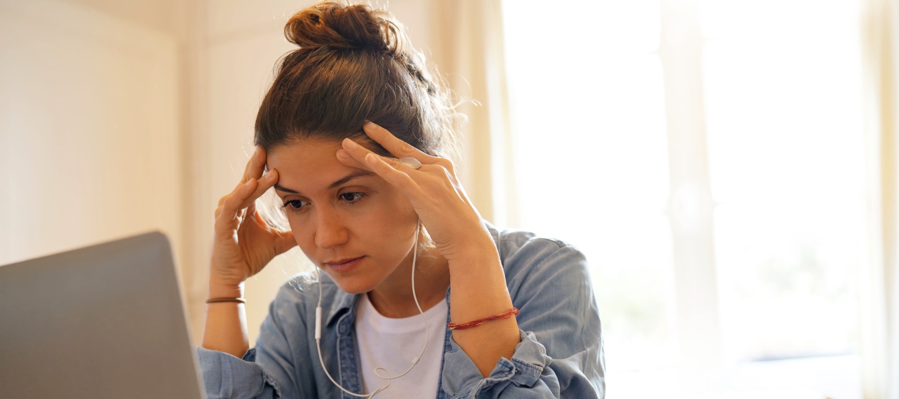 Stressed young woman working with laptop from home - Meredith Law Firm, LLC - Foreclosure Attorneys - -North Charleston, SC