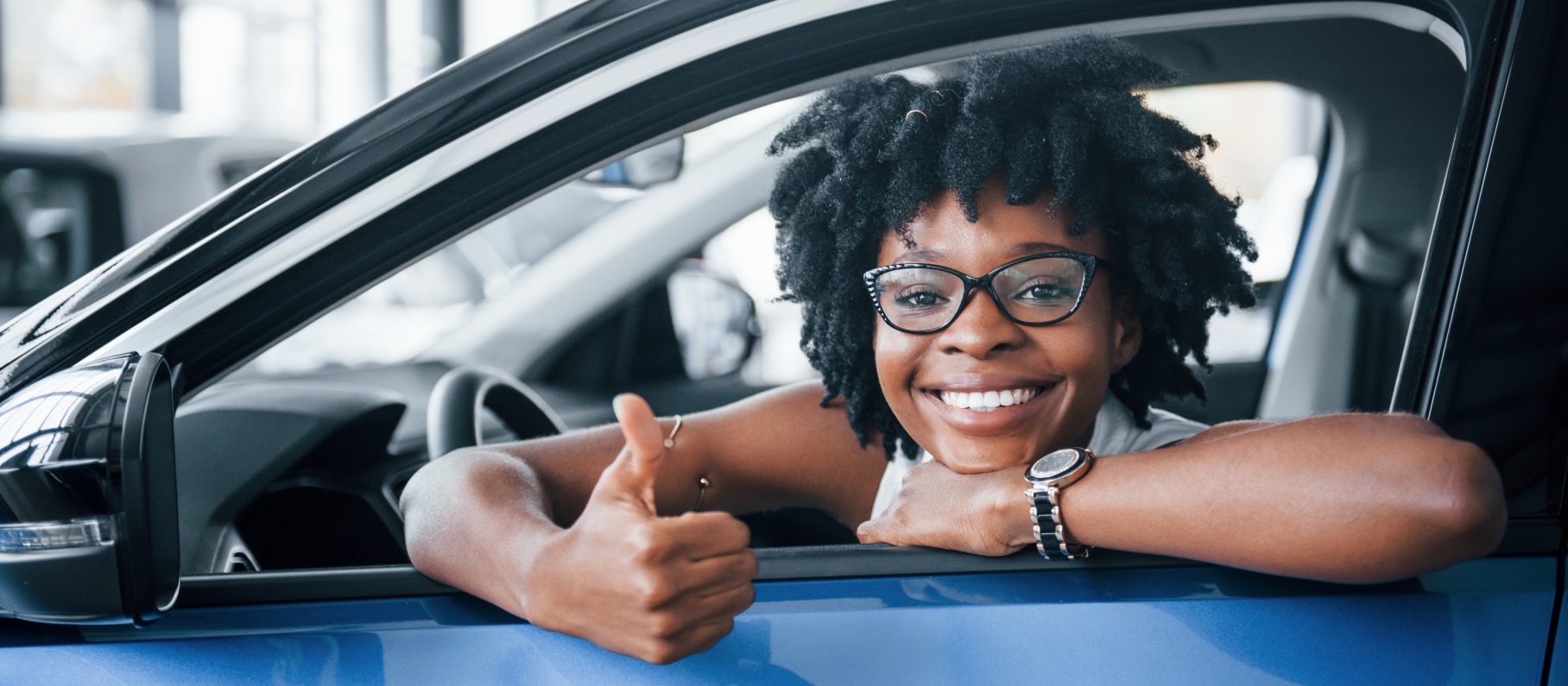 A women leaning out her car window with hands up - Meredith Law Firm, LLC - Chapter 7 Bankruptcy - North Charleston, SC