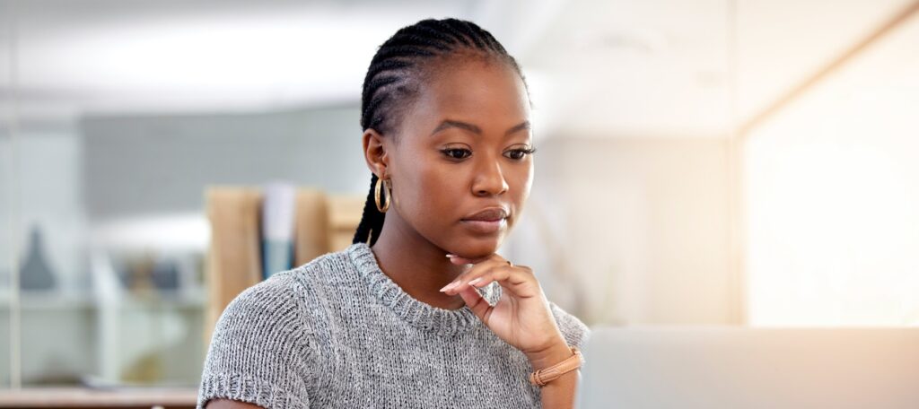 Woman working on a laptop searching for a bankruptcy law firm.