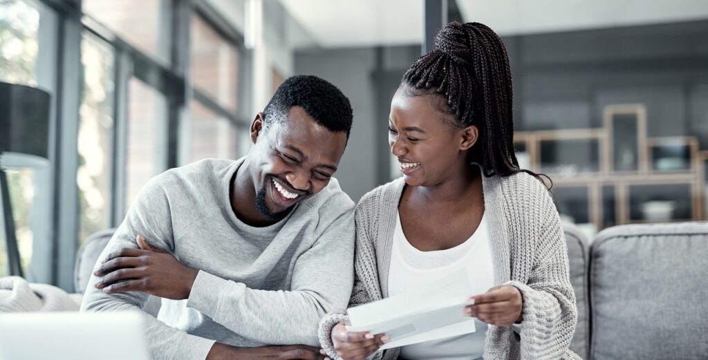 Happy black couple paying bills on a laptop at home. chapter 13 Bankruptcy